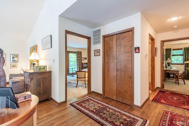 foyer with light wood-type flooring, visible vents, and a wealth of natural light