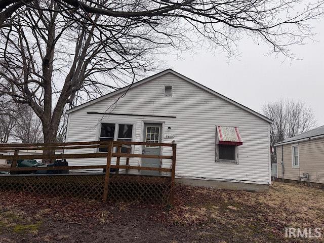 rear view of house featuring a wooden deck