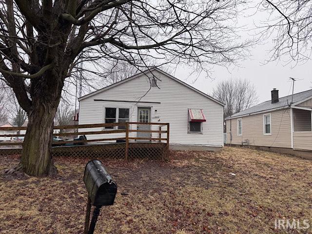 back of property featuring a wooden deck