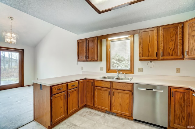 kitchen with brown cabinetry, dishwasher, a peninsula, and a sink