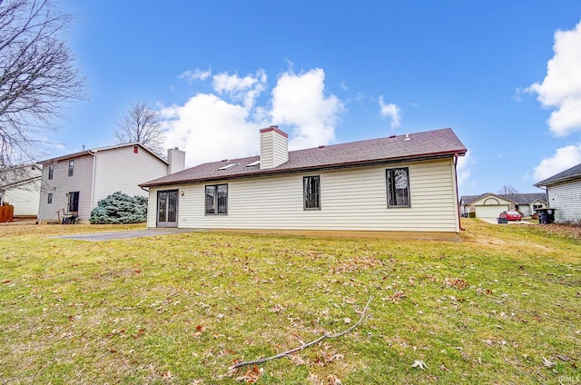 rear view of property with a lawn and a chimney