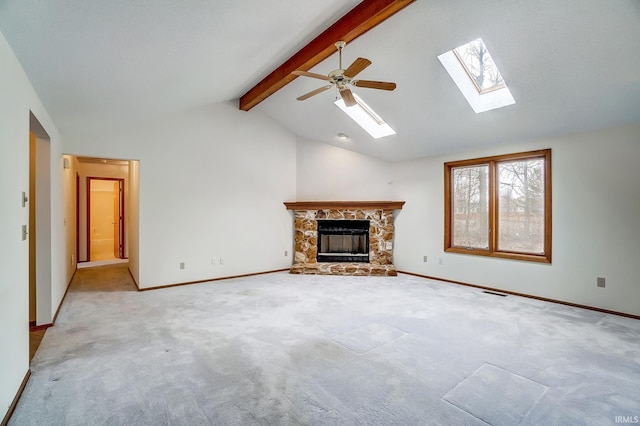 unfurnished living room with visible vents, baseboards, lofted ceiling with beams, carpet flooring, and a stone fireplace