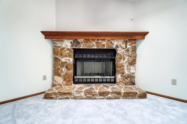 room details featuring carpet, a stone fireplace, and baseboards