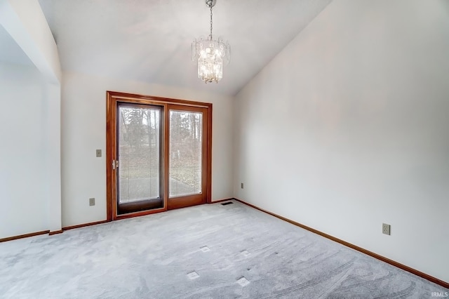 spare room with a notable chandelier, visible vents, carpet flooring, vaulted ceiling, and baseboards