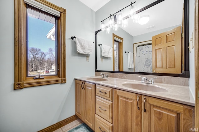 bathroom with a sink, visible vents, baseboards, and double vanity