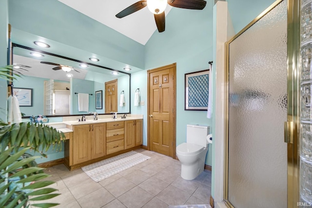 bathroom featuring tile patterned flooring, lofted ceiling, double vanity, a stall shower, and a sink