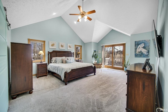 bedroom with light carpet, access to exterior, a textured ceiling, a barn door, and ceiling fan