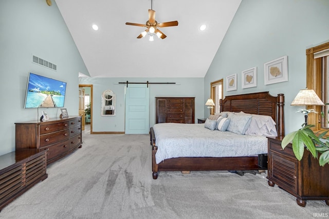 bedroom featuring visible vents, ceiling fan, a barn door, carpet flooring, and high vaulted ceiling