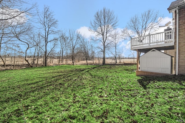 view of yard with a deck and an outbuilding