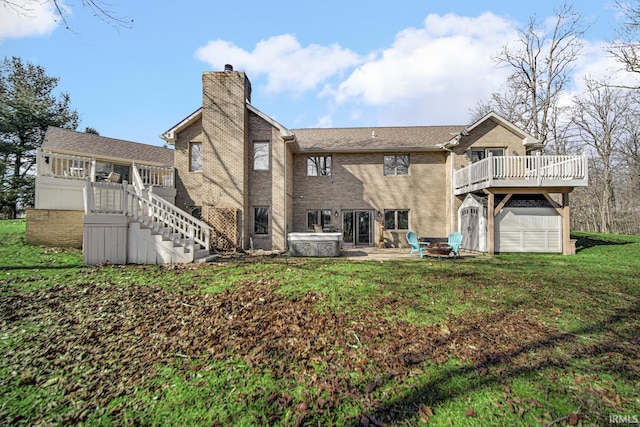 rear view of property featuring stairway, a chimney, a yard, a deck, and a patio