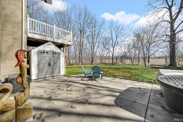 view of patio with a wooden deck, a storage unit, and an outdoor structure