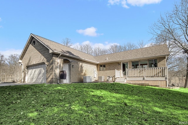 single story home with a porch, central air condition unit, brick siding, and a front lawn