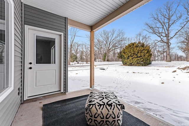 view of snow covered property entrance