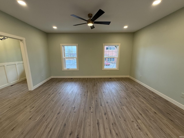 unfurnished room with ceiling fan, baseboards, wood finished floors, and recessed lighting