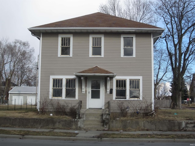 view of front of house with a shingled roof and a detached garage