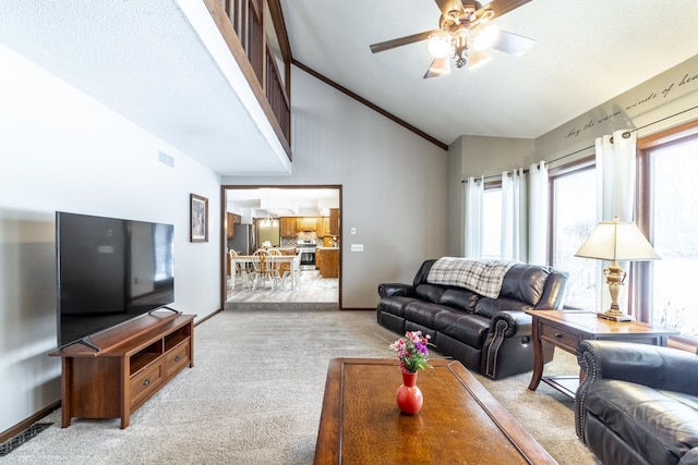 living area featuring a ceiling fan, ornamental molding, light carpet, high vaulted ceiling, and baseboards