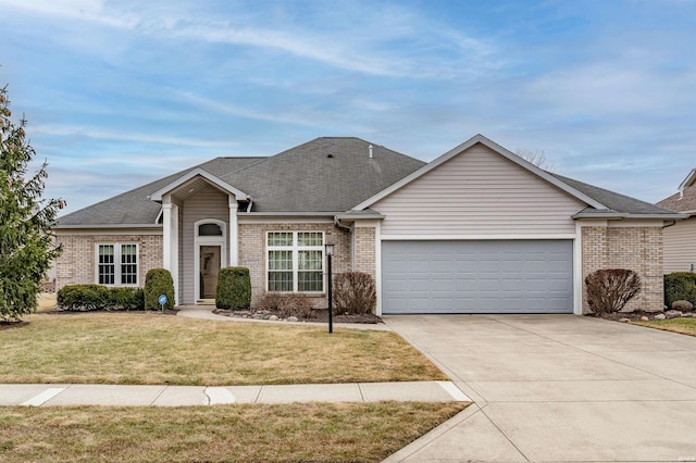 view of front of home featuring driveway, a front lawn, an attached garage, and brick siding