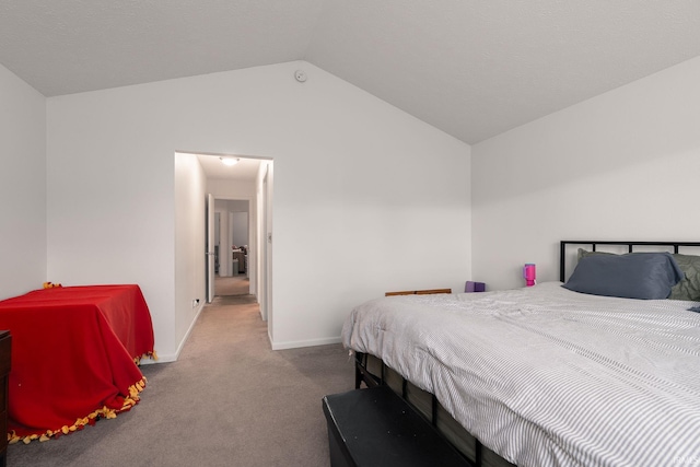 bedroom featuring carpet, lofted ceiling, and baseboards