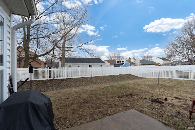 view of yard with a fenced backyard and a residential view