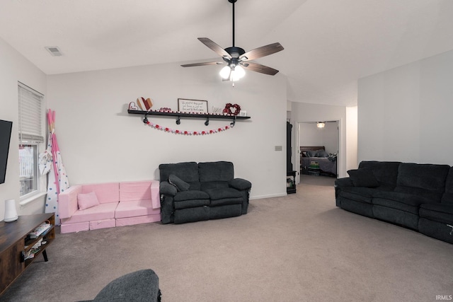 carpeted living area featuring visible vents, vaulted ceiling, and a ceiling fan