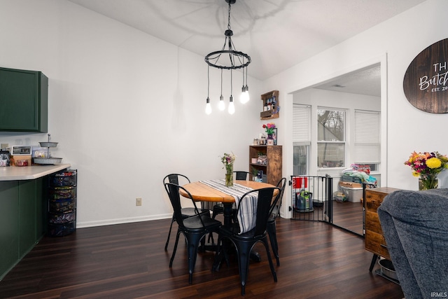 dining room featuring dark wood-type flooring and baseboards