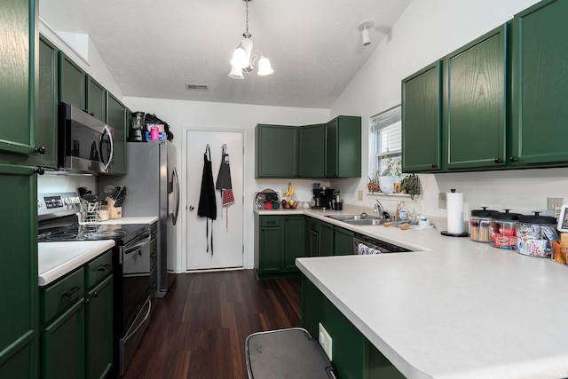 kitchen featuring appliances with stainless steel finishes, light countertops, visible vents, and green cabinets