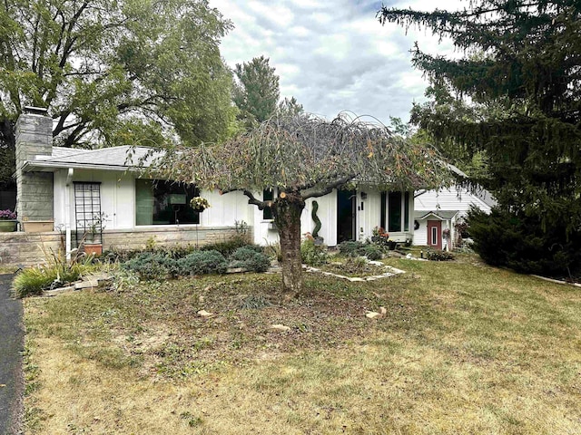 view of front of home with a front lawn and a chimney