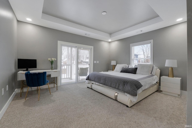 carpeted bedroom featuring baseboards, a tray ceiling, recessed lighting, and access to exterior