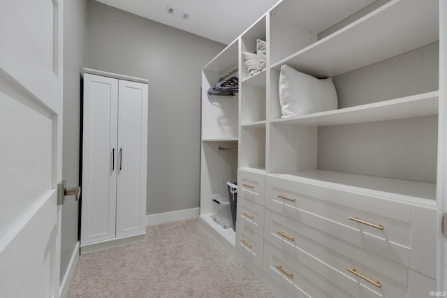 spacious closet with visible vents and light colored carpet