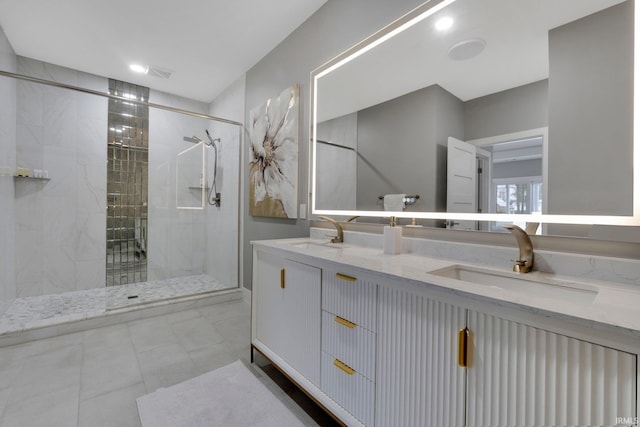 bathroom with a sink, a shower stall, and double vanity