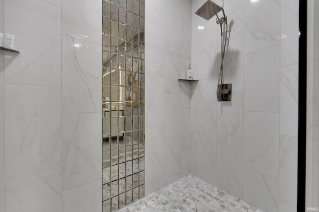 bathroom with tiled shower