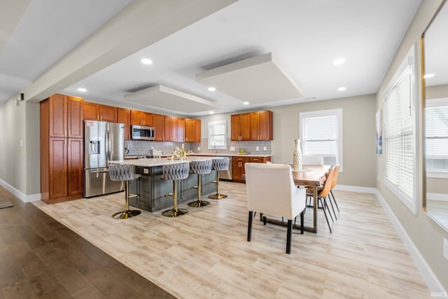 dining area featuring light wood-type flooring, baseboards, and recessed lighting