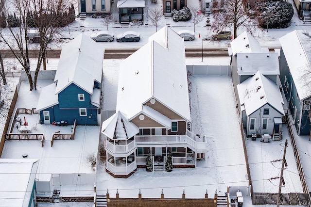 snowy aerial view featuring a residential view