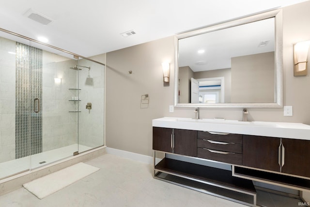 full bath with a stall shower, visible vents, baseboards, and double vanity