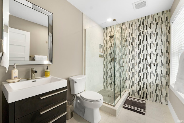 full bathroom featuring visible vents, toilet, a shower stall, vanity, and tile patterned flooring