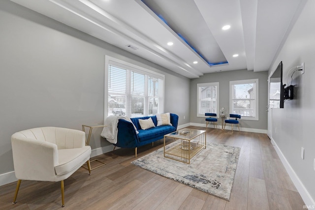 living area with recessed lighting, wood finished floors, visible vents, and baseboards