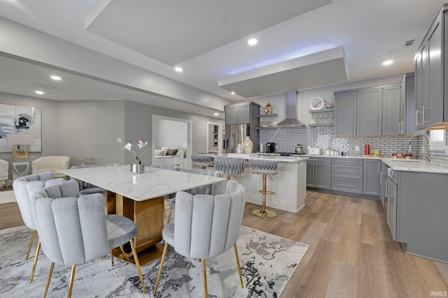 dining room featuring visible vents, light wood-style flooring, and recessed lighting