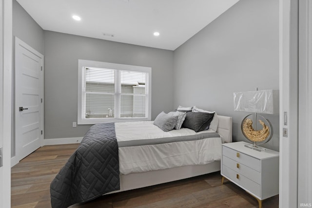 bedroom with baseboards, wood finished floors, visible vents, and recessed lighting