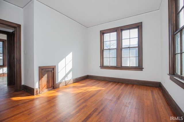 interior space with baseboards and hardwood / wood-style floors