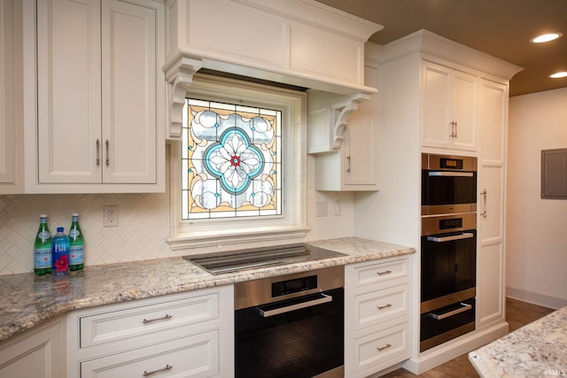 kitchen with a warming drawer, recessed lighting, double oven, white cabinetry, and black electric cooktop