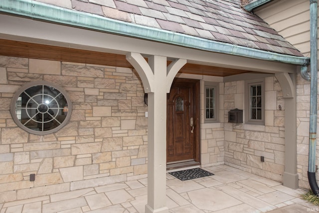 view of exterior entry featuring stone siding