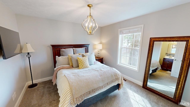 bedroom with a chandelier, carpet flooring, and baseboards