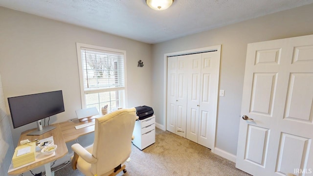 home office with baseboards and light colored carpet