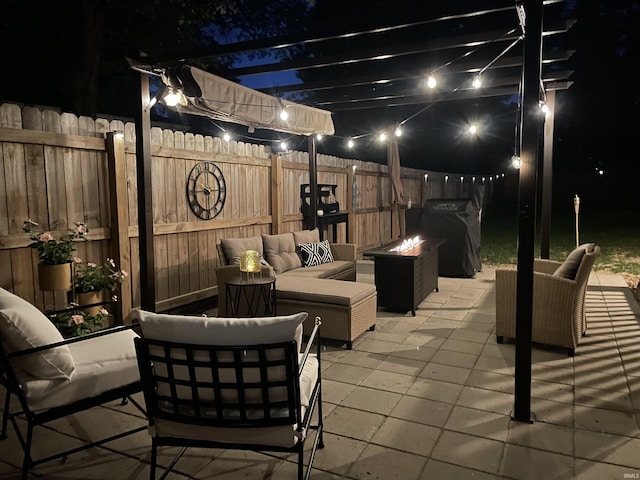 patio at night with outdoor lounge area and fence