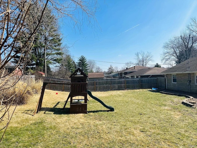 view of yard with a playground and fence