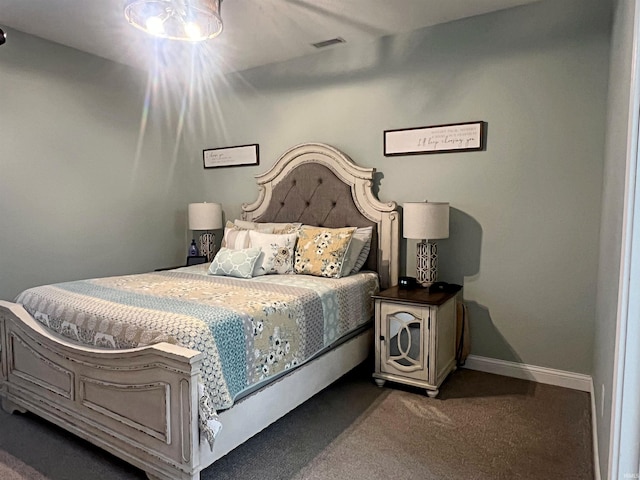 carpeted bedroom with visible vents and baseboards