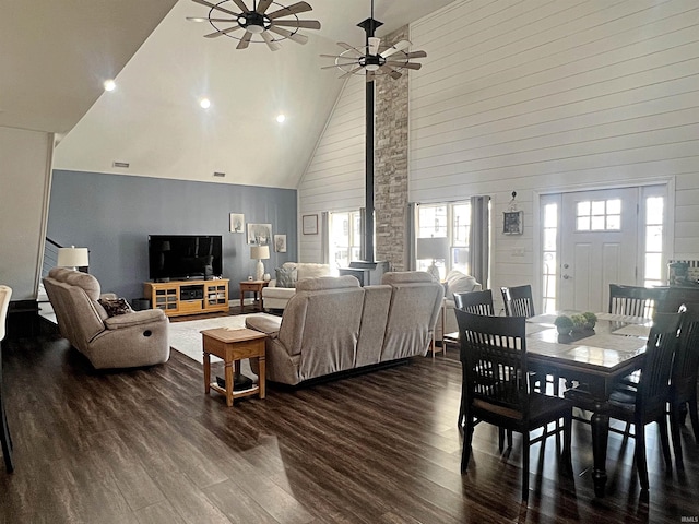 living area with ceiling fan, high vaulted ceiling, wood finished floors, and visible vents