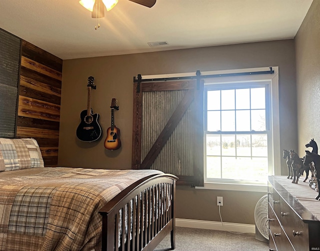 bedroom with carpet floors, baseboards, visible vents, and a ceiling fan