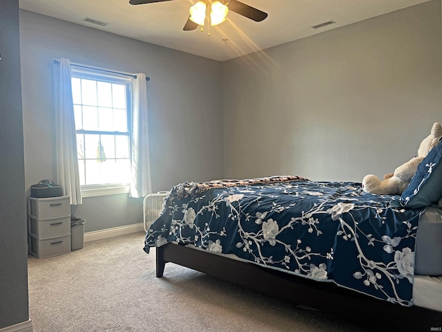 carpeted bedroom with baseboards, visible vents, and ceiling fan