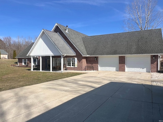 view of front of house with a garage, concrete driveway, roof with shingles, a front lawn, and brick siding